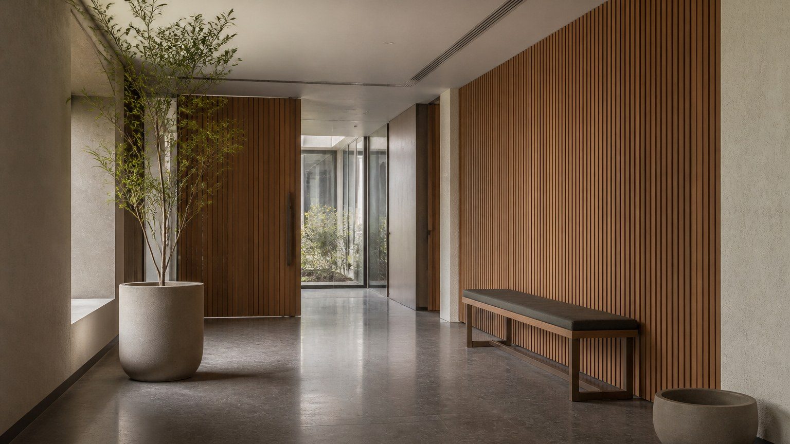 Calm client-facing office arrival with stone, timber and controlled daylight