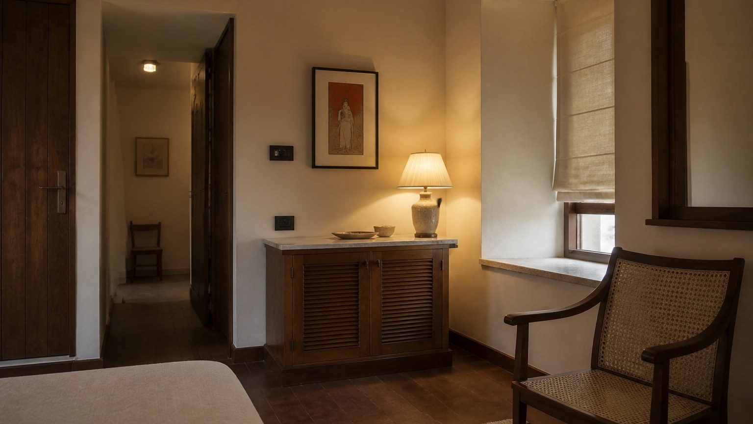 Settled residential room in warm evening light, few objects, plaster and timber