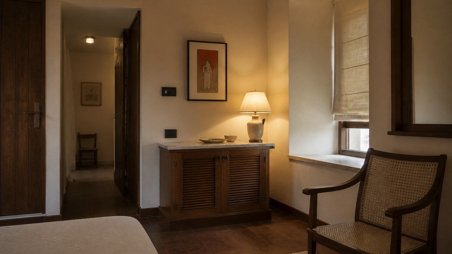Settled residential room in warm evening light, few objects, plaster and timber