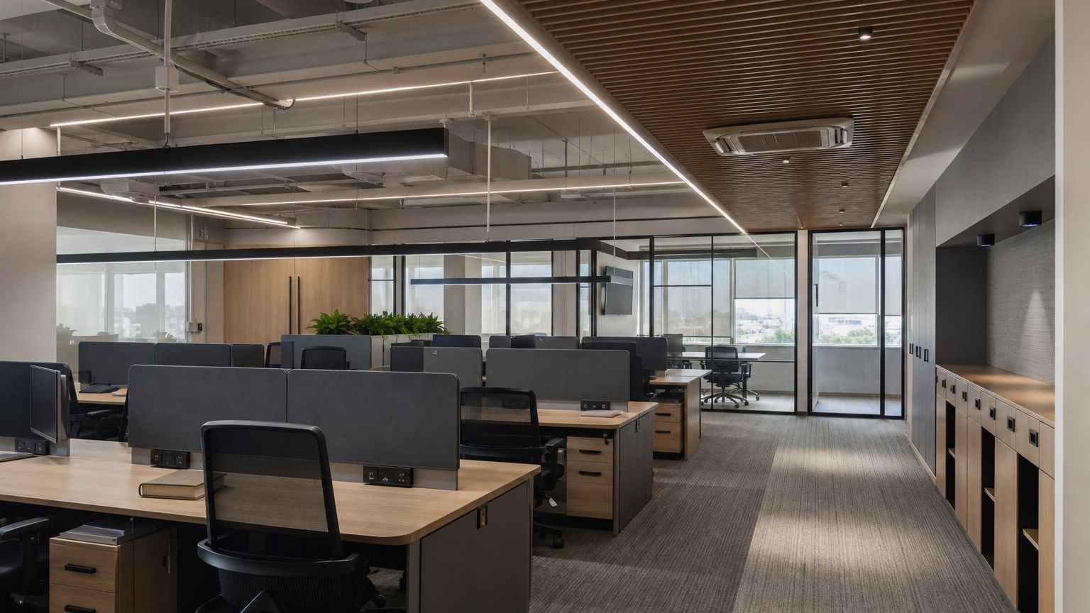 Small contemporary office floor with adaptable desks and a quiet meeting edge, empty