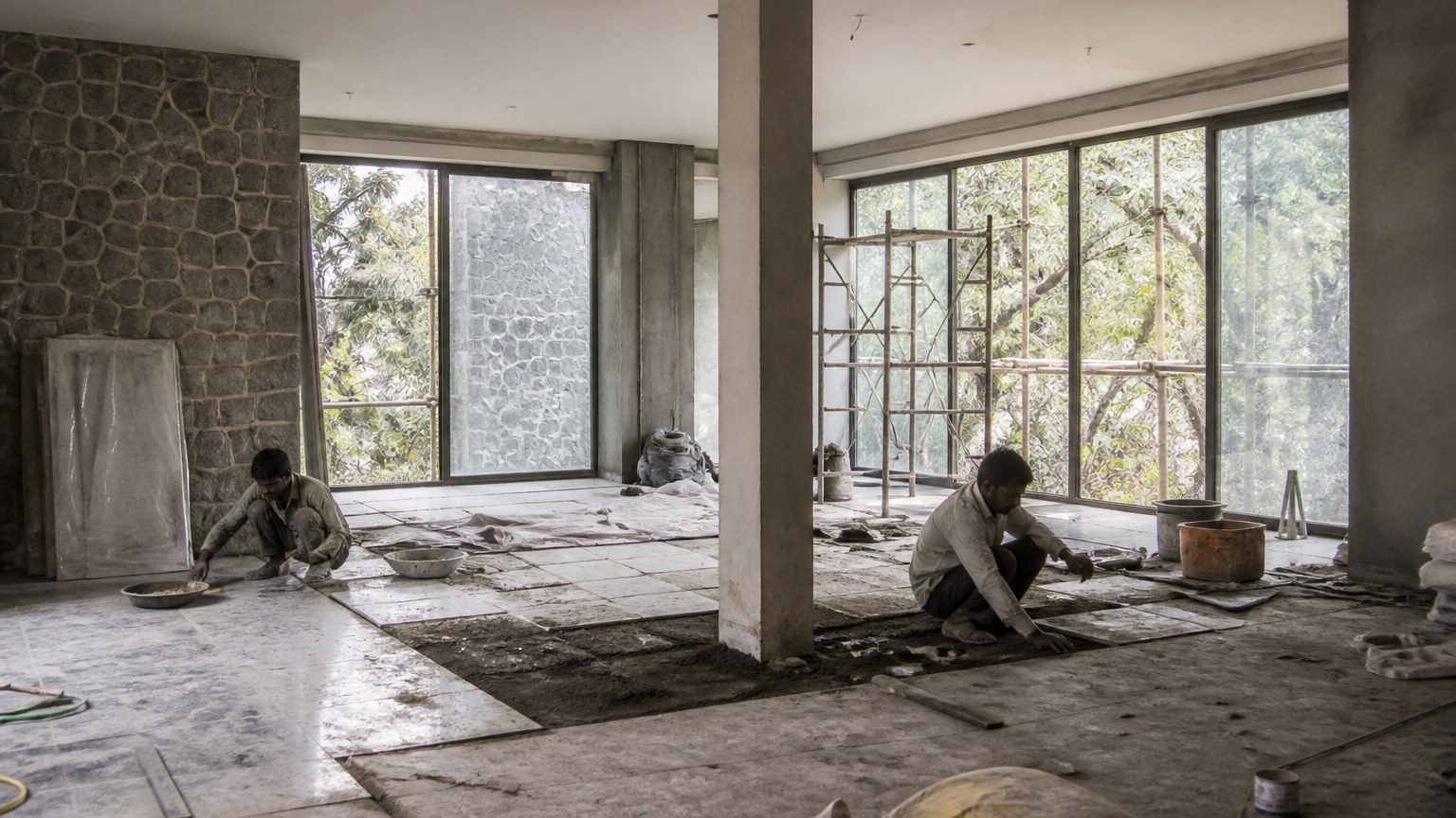 Honest in-progress interior on an Indian residential site, stone being laid