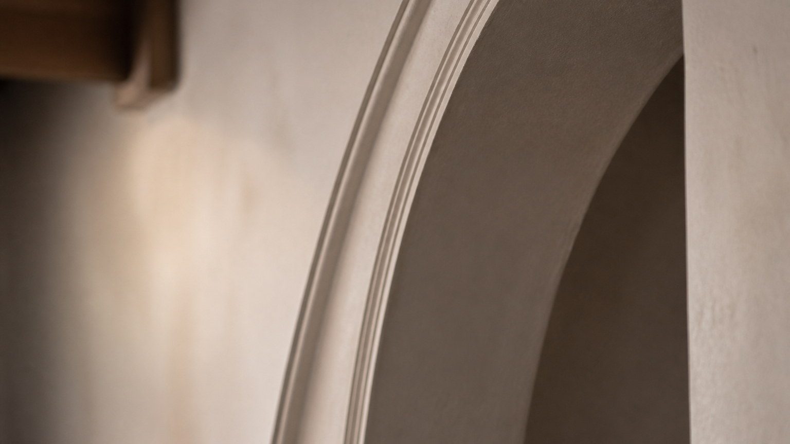 Detail of a curved millwork or arched plaster reveal with shadow in the radius