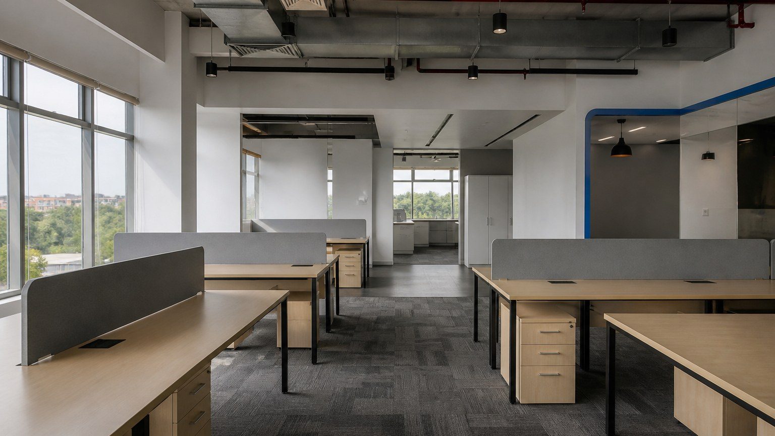 Open small office with a simple desk grid and daylight, ready to be re-arranged