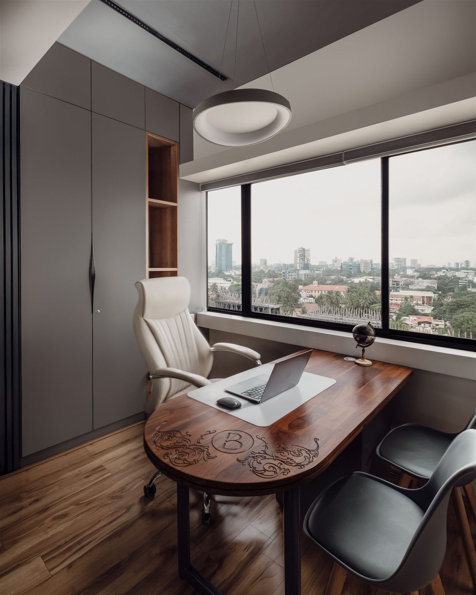 Office cabin with cream leather chair and carved desk