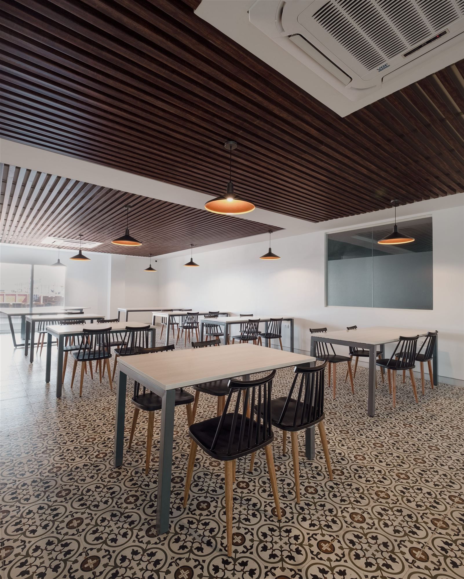 Cafeteria with patterned heritage-style tile floor and pendant lighting