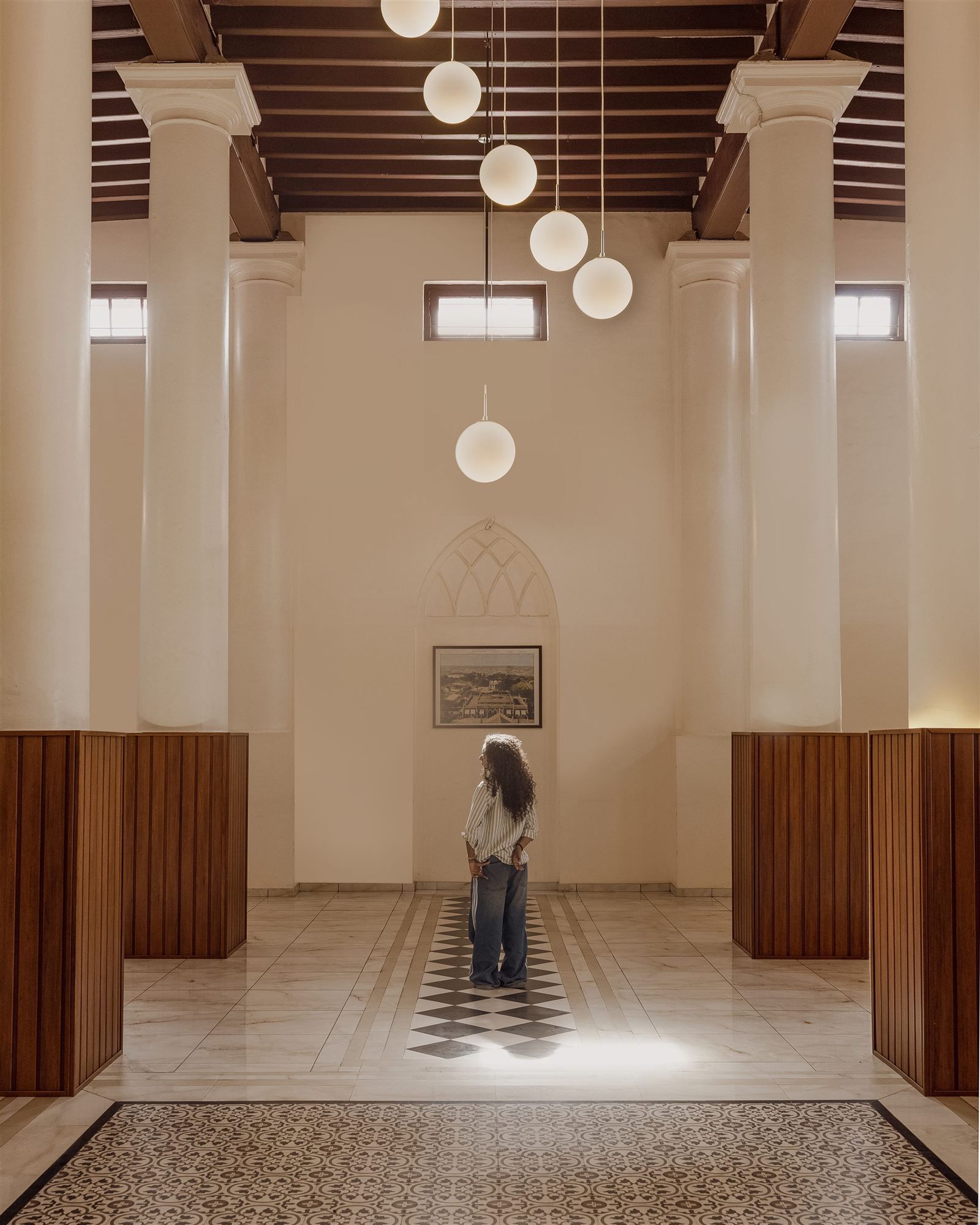 Main hall with checkerboard floor and ceiling fan