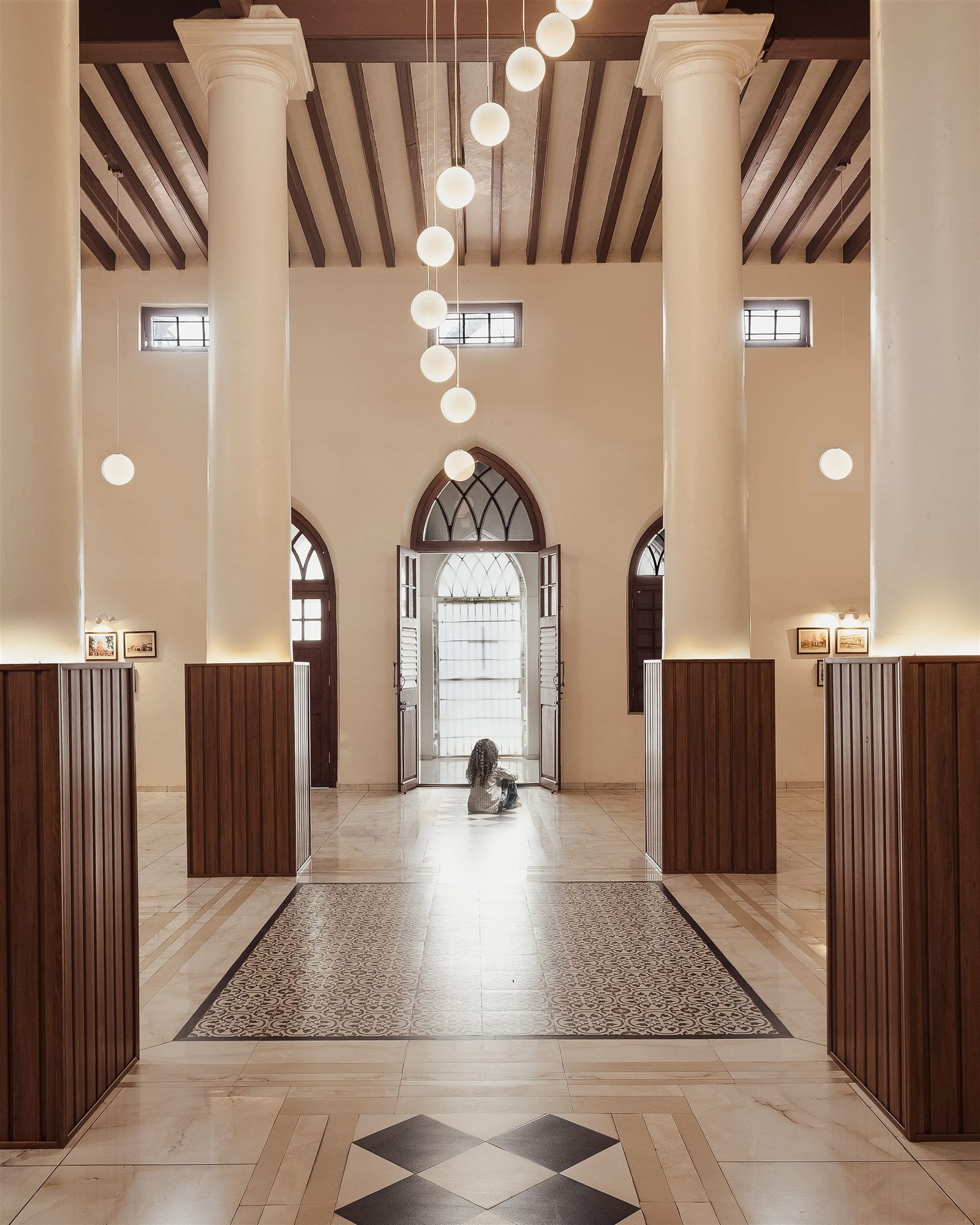 St. Andrew's Church Parish Hall — restored colonnaded hall with pendant globe chandelier