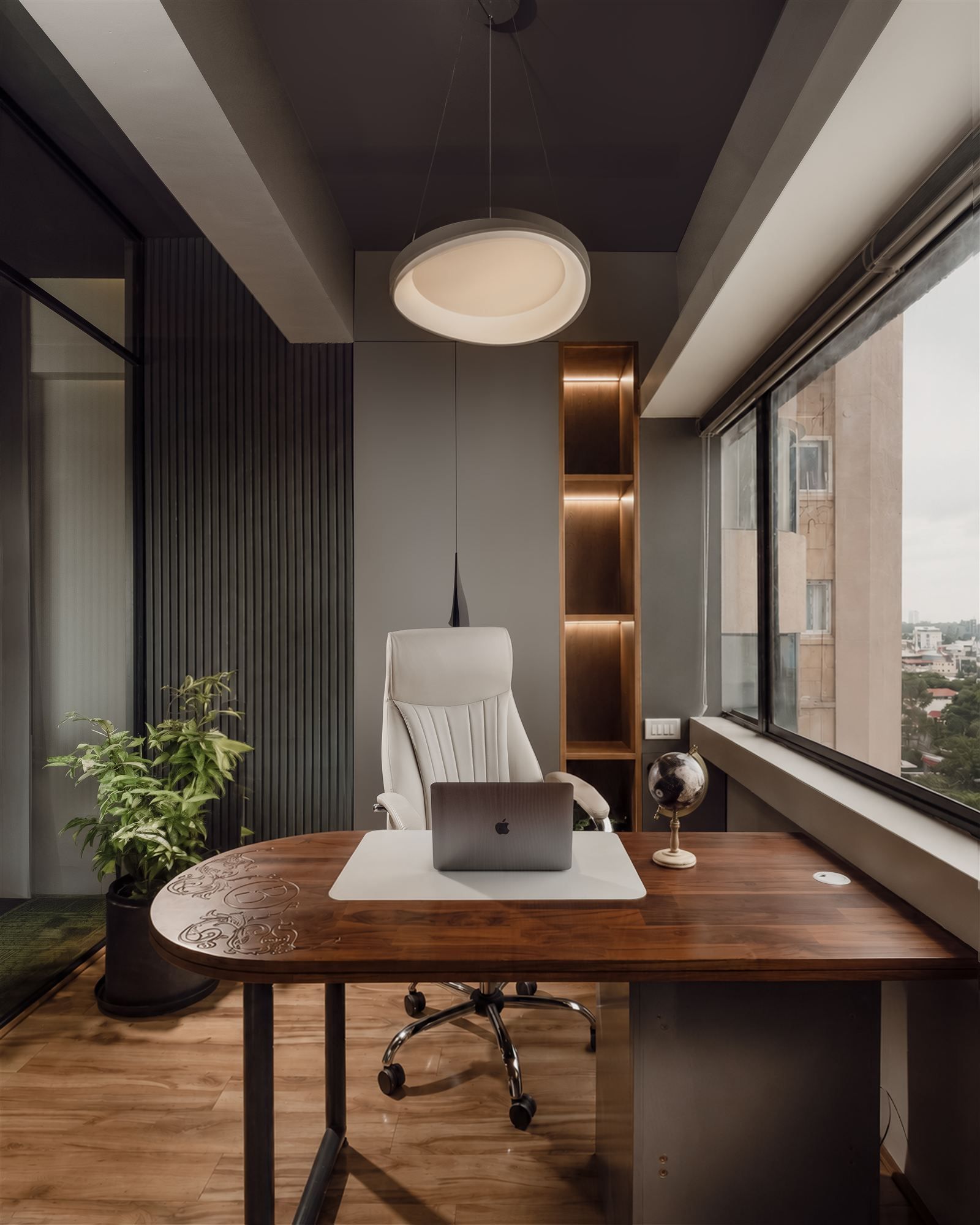Blucap's own office cabin with carved walnut desk and city view
