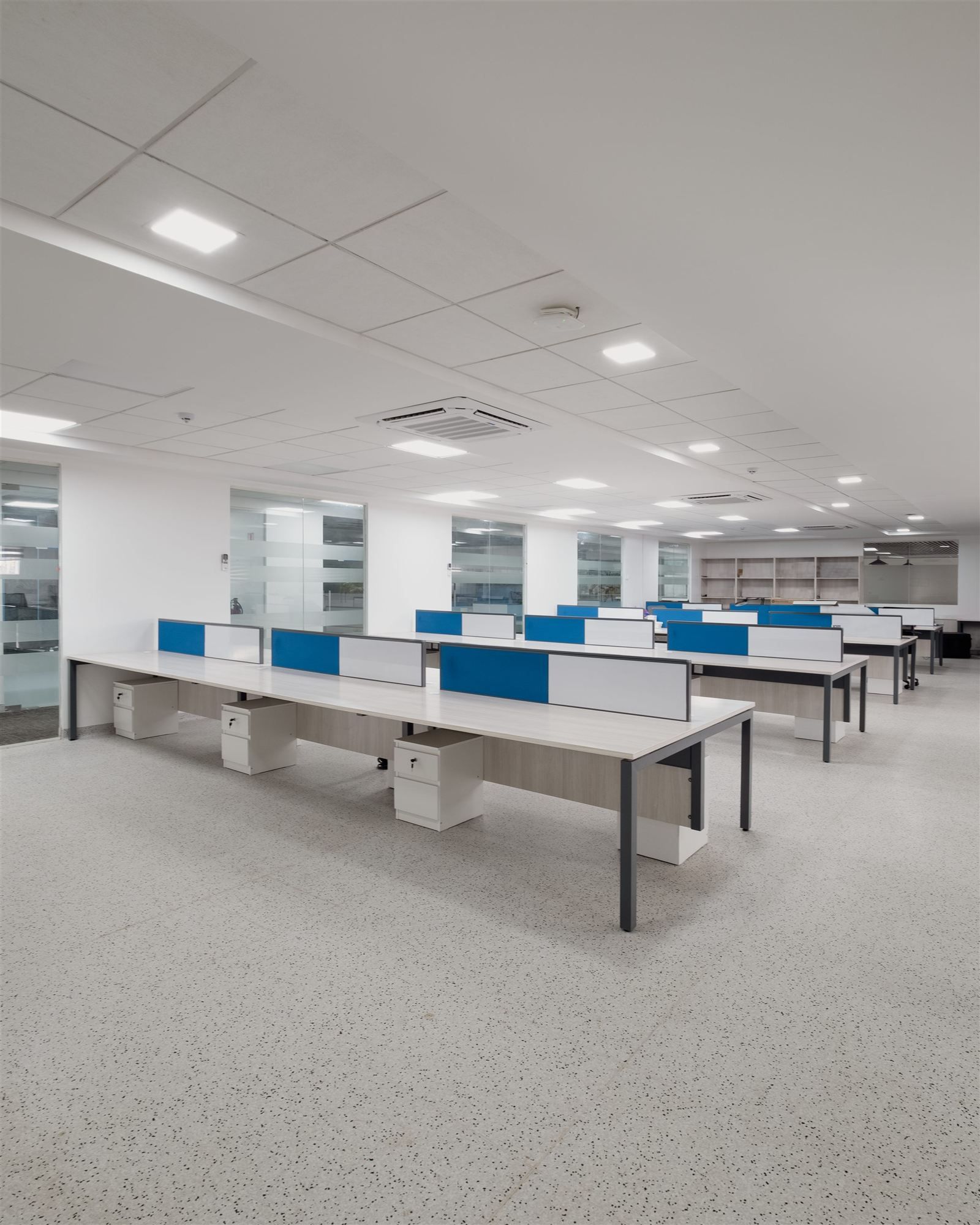 Open-plan workstations with blue-accent partitions