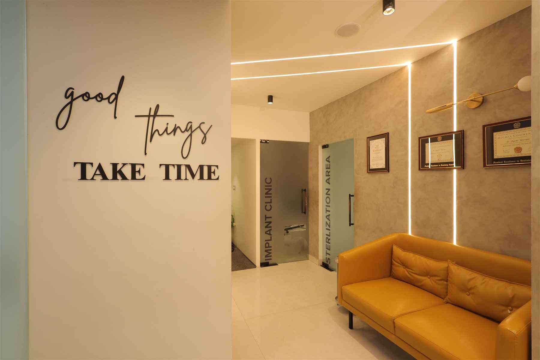 "Good things take time" wall art beside the implant clinic corridor and certificate wall
