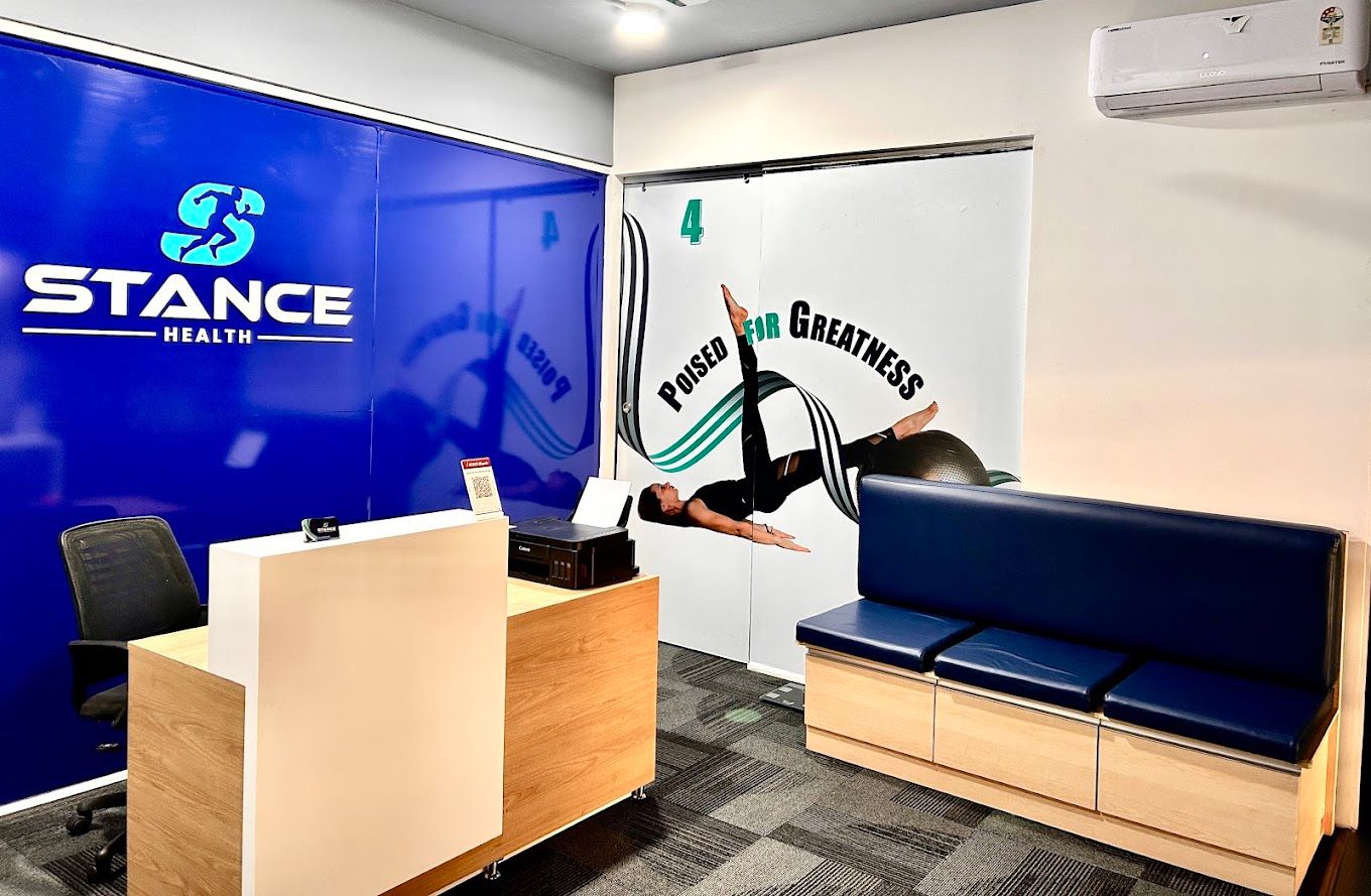 Reception desk with blue Stance Health wall and navy waiting bench